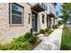 Inviting townhome facade with brick detailing, elegant door, and professionally landscaped walkway at 2669 Caruso Way, Atlanta, GA 30339