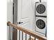 Hallway with stackable washer and dryer behind a door at 2669 Caruso Way, Atlanta, GA 30339