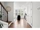 Bright hallway with hardwood floors leading to a modern kitchen with island seating and natural light at 2669 Caruso Way, Atlanta, GA 30339