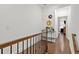 Bright hallway features hardwood floors, elegant staircase and decorative elements enhancing the home's interior design at 2669 Caruso Way, Atlanta, GA 30339