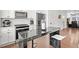 Modern kitchen with white cabinets, black marble island, stainless steel appliances, and counter seating at 2669 Caruso Way, Atlanta, GA 30339