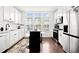 Bright kitchen with modern appliances, black marble island with seating, and natural light from three windows at 2669 Caruso Way, Atlanta, GA 30339