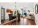 Open-concept living room with hardwood floors, a dining area, and stylish furnishings creating a comfortable space at 2669 Caruso Way, Atlanta, GA 30339