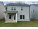 Two-story home exterior featuring a covered patio and a well-maintained lawn at 4534 Eastbrook Pl, Snellville, GA 30039