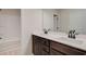 Bathroom featuring a double vanity with dark wood cabinets and white countertop, plus a bathtub at 4534 Eastbrook Pl, Snellville, GA 30039