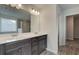 A bathroom featuring a double vanity with dark wood cabinets and white countertop, plus a walk-in shower at 4534 Eastbrook Pl, Snellville, GA 30039