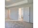 The bedroom includes neutral carpeting, light-colored walls and trim, and a hallway and doorway to the bedroom at 4534 Eastbrook Pl, Snellville, GA 30039