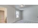 A bedroom with neutral walls and carpeting and a large window that provides plenty of natural light at 4534 Eastbrook Pl, Snellville, GA 30039