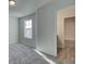 A bedroom with neutral colored walls, carpeting, and trim, plus an en suite bathroom is visible through the open doorway at 4534 Eastbrook Pl, Snellville, GA 30039