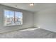 A naturally lit bedroom featuring neutral-colored walls, carpeting, and a large window with a view at 4534 Eastbrook Pl, Snellville, GA 30039