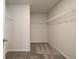 Walk-in closet with white wire shelving and neutral colored carpeting at 4534 Eastbrook Pl, Snellville, GA 30039