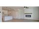 Open concept living room with hardwood floors, a modern fireplace, and a kitchen at 4534 Eastbrook Pl, Snellville, GA 30039