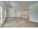 Open living room with hardwood floors, a kitchen, and a staircase to the upper level at 4534 Eastbrook Pl, Snellville, GA 30039