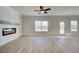 Well-lit living room featuring a modern electric fireplace and hardwood floors at 4534 Eastbrook Pl, Snellville, GA 30039