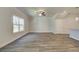 Spacious living room with hardwood floors, a ceiling fan, and a large window at 4534 Eastbrook Pl, Snellville, GA 30039