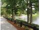 A tranquil pond surrounded by trees, with a walking path and fountain at 4534 Eastbrook Pl, Snellville, GA 30039