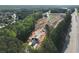 An aerial view of a new home under construction with lush greenery surrounding the community and highway nearby at 4659 Larkfield Way, Powder Springs, GA 30127
