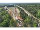 Aerial view of new home construction community surrounded by lush trees and greenery next to a highway at 4659 Larkfield Way, Powder Springs, GA 30127