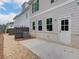 Neutral toned exterior showing a walk out back door and small patio surrounded by gravel at 4659 Larkfield Way, Powder Springs, GA 30127