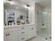 Bright bathroom with double vanity, quartz countertops, and a glass enclosed shower with marble tiling at 4659 Larkfield Way, Powder Springs, GA 30127