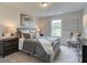 Bedroom with large window, neutral colors, and comfortable furnishings at 4659 Larkfield Way, Powder Springs, GA 30127