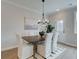 Cozy dining area featuring a modern chandelier, seating for six and an outdoor view at 4659 Larkfield Way, Powder Springs, GA 30127