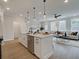 Open concept kitchen with a large center island and views of the living area at 4659 Larkfield Way, Powder Springs, GA 30127