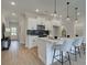 Modern kitchen with white cabinets, a black backsplash, and a center island with seating, great for entertaining at 4659 Larkfield Way, Powder Springs, GA 30127