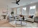 Open concept living room with contemporary furnishings, a decorative rug, and dining area nearby at 4659 Larkfield Way, Powder Springs, GA 30127
