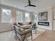 Inviting living room with a cozy fireplace, plush seating, and plenty of natural light at 4659 Larkfield Way, Powder Springs, GA 30127
