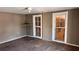 Bedroom featuring hardwood floors, natural light and two windows needing repair at 700 W College St, Bowdon, GA 30108