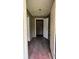 Entryway into the house with hardwood floors and an open doorway at 700 W College St, Bowdon, GA 30108