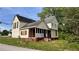 Back side of a two-story house with a screened porch and overgrown yard at 700 W College St, Bowdon, GA 30108