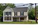 An exterior view of a two-story home with light yellow siding and black shutters at 700 W College St, Bowdon, GA 30108