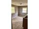 Kitchen featuring tile floors, natural light and a stainless steel sink needing repair at 700 W College St, Bowdon, GA 30108