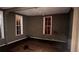 Living Room of the house with two window views and hardwood floors at 700 W College St, Bowdon, GA 30108