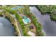 Community pool and tennis courts bordering a serene lake surrounded by mature trees and landscaping at 7979 Larksview Dr, Fairburn, GA 30213