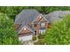 Aerial view of a red brick house with a lush green trees at 7979 Larksview Dr, Fairburn, GA 30213