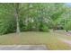 Large backyard area featuring mature trees at 7979 Larksview Dr, Fairburn, GA 30213