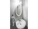 Powder room featuring white pedestal sink, oval mirror, and neutral gray paint at 7979 Larksview Dr, Fairburn, GA 30213