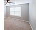 A standard bedroom with carpet flooring, neutral wall paint, and a window for natural light at 7979 Larksview Dr, Fairburn, GA 30213