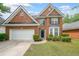 Charming two-story brick home featuring a well-manicured lawn and attached two-car garage at 7979 Larksview Dr, Fairburn, GA 30213
