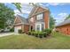 Beautiful two-story brick house with manicured lawn, mature landscaping, and attached two-car garage at 7979 Larksview Dr, Fairburn, GA 30213
