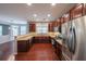 Bright kitchen with stainless steel appliances, dark wood cabinets, and views of the breakfast nook at 7979 Larksview Dr, Fairburn, GA 30213
