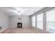Inviting living room featuring a fireplace, neutral paint colors, and large windows for natural light at 7979 Larksview Dr, Fairburn, GA 30213