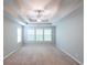 Bright main bedroom featuring carpeted floor, ceiling fan, and natural light at 7979 Larksview Dr, Fairburn, GA 30213