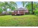 View of a large backyard with a wooden deck attached to a brick house at 949 Hope Sw Dr, Atlanta, GA 30310