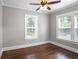 Bedroom featuring hardwood floors, ceiling fan, neutral decor, and bright natural light at 949 Hope Sw Dr, Atlanta, GA 30310