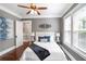 Comfortable bedroom with hardwood floors, ceiling fan, neutral walls, and bright natural light at 949 Hope Sw Dr, Atlanta, GA 30310