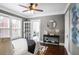 Comfortable bedroom with hardwood floors, ceiling fan, and access to a private sitting room at 949 Hope Sw Dr, Atlanta, GA 30310